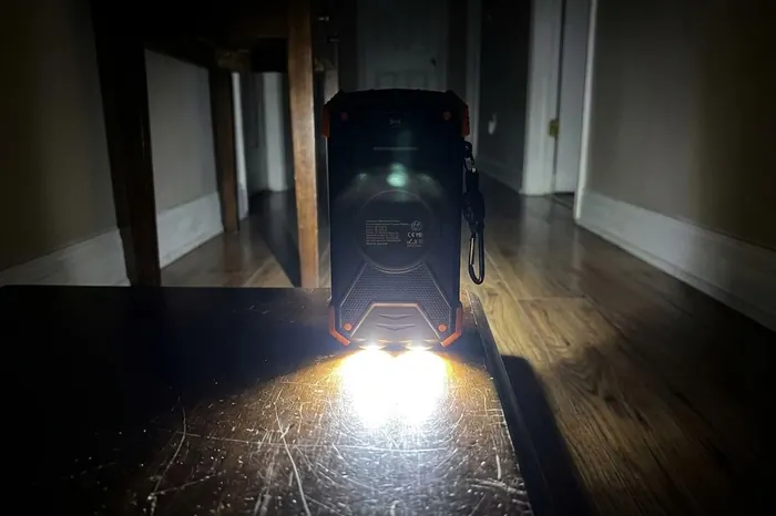 The power bank's twin LED flashlight lighting a dark hallway during an outage